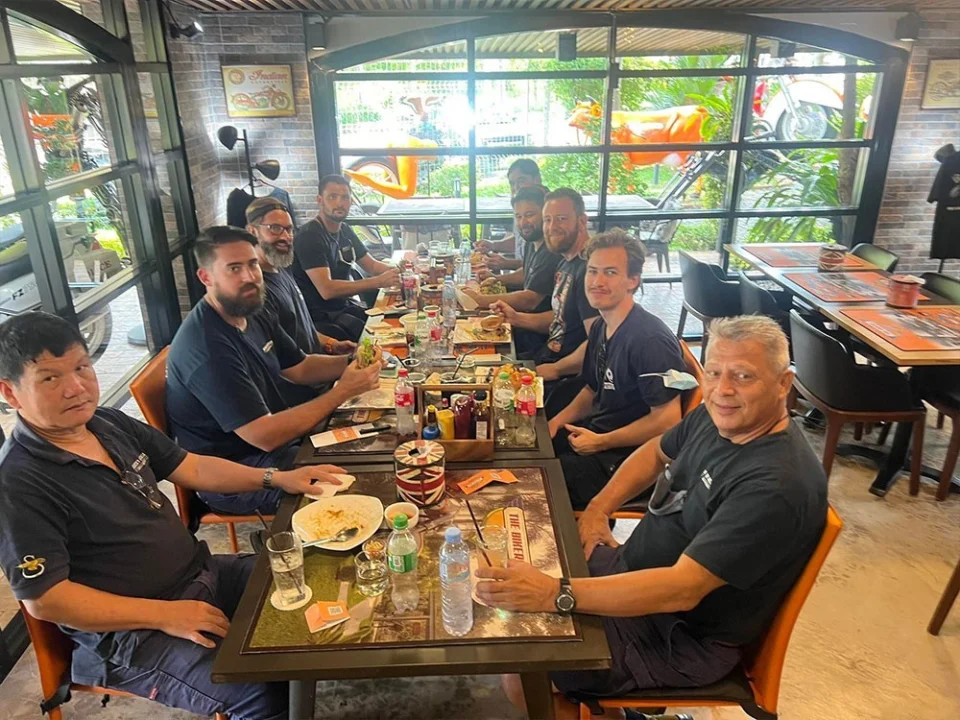 A long table of riders at lunch