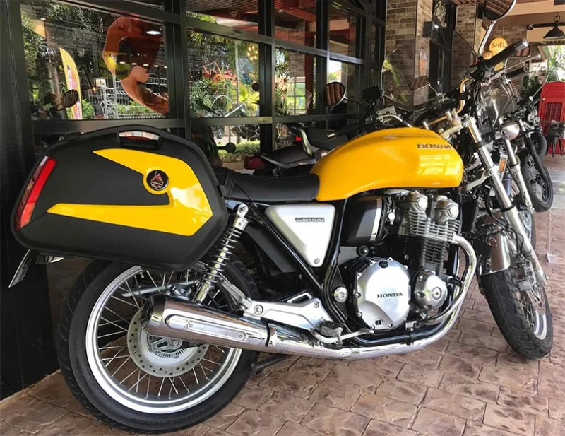 A yellow Honda CB 1100 EX with touring cases on the terrace